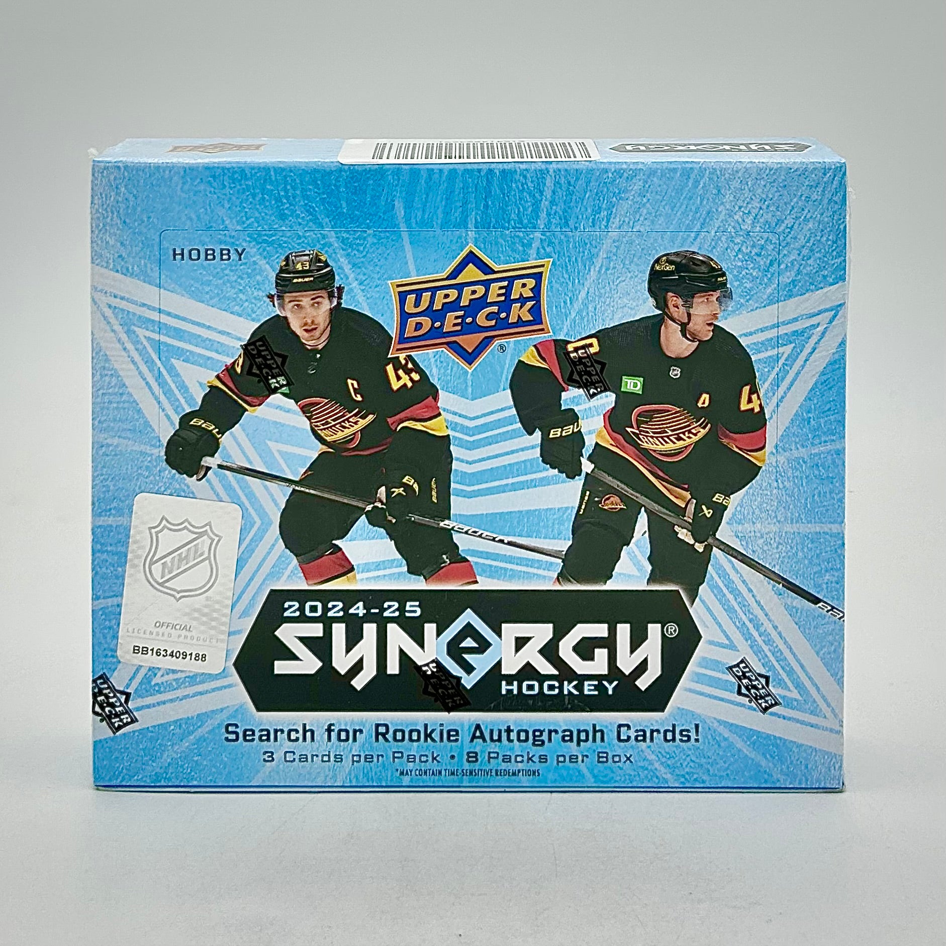 A hobby box of 2024-25 Upper Deck Synergy Hockey cards featuring two hockey players on the packaging.