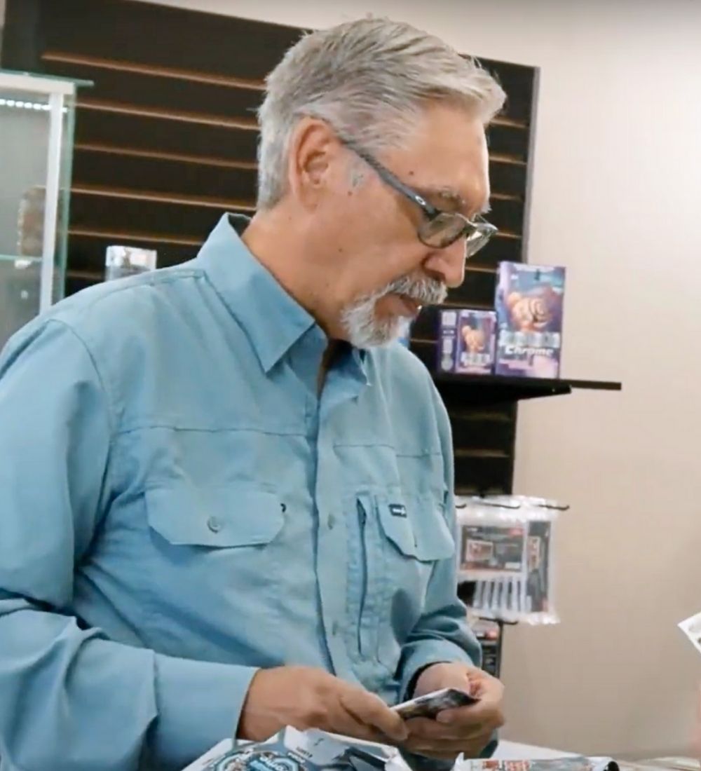 Man looking down at sports cards